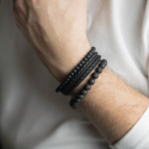 Mature man posing with bracelets